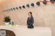 A woman standing at the front desk of a hotel.