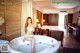 A woman sitting in a bathtub in a hotel room.